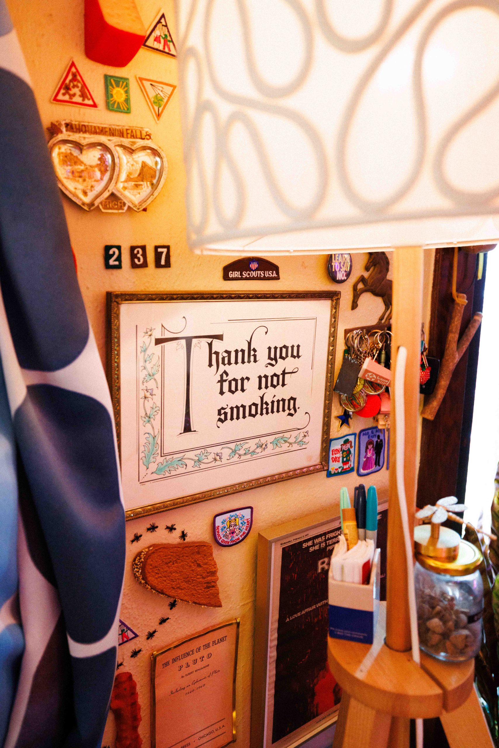 A wall of framed signs and mementos, including a sign reading Thank you for not smoking.